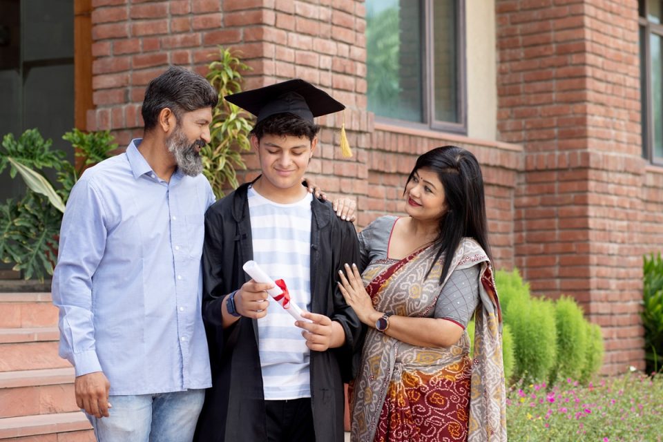 Parents and child celebrating university graduation.