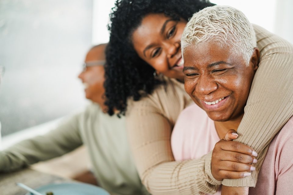 Mother and daughter hugging.